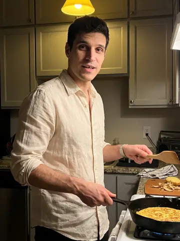 Martín, AI character: his small Boston apartment kitchen on a Sunday night, a cassette player and cutting board on the counter