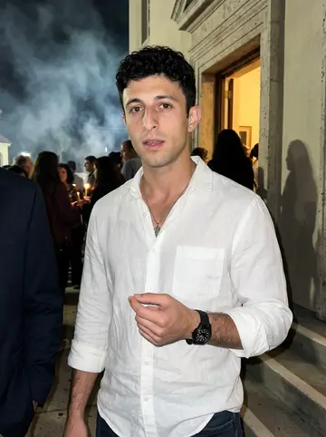 Fotis, AI character: outside the Greek Orthodox church in Tarpon Springs after midnight Easter service, people and fireworks…