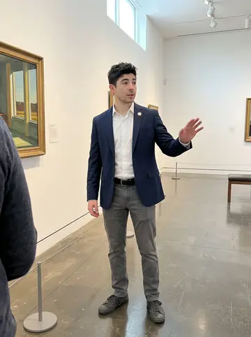 Bernardino, AI character: the east wing of the Fall River museum, near a Hopper painting and a low rope barrier