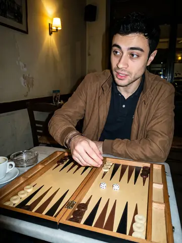 Stelios, AI character: a kafeneio in Thessaloniki at night, sitting at a small table with a backgammon board, coffee cups and an…