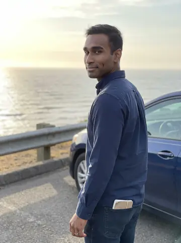Nathan, AI character: a quiet pullout above the Oregon coast on his day off, ocean and low guardrail behind him, his dark blue…