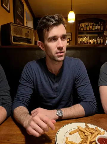 Shawn, AI character: a small Worcester neighborhood pub after shift, sitting in a corner booth with two coworkers cropped out…