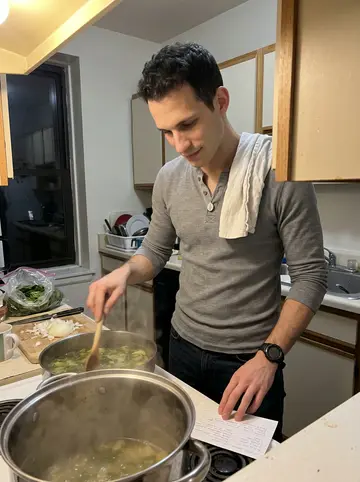 Antonio, AI character: Nonna Rosa's kitchen in Federal Hill, phone propped low on the counter while a pot of escarole soup simmers
