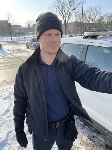 Ørjan, AI character: the frozen Lake Mendota shoreline near Picnic Point in Madison, snow packed along the path and bare trees…