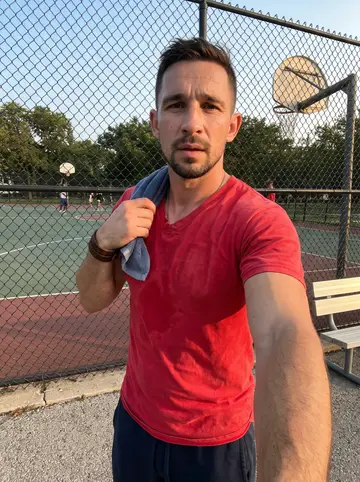 Nemanja, AI character: outside a Serbian church hall on the North Side of Chicago before his cousin's slava, leaning against a…