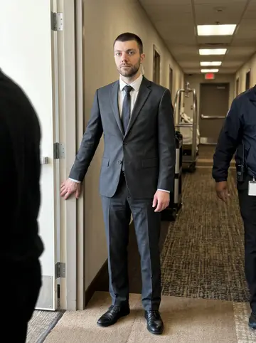 Oleh, AI character: service hallway of a downtown Houston hotel before a charity reception, security staff moving in the…