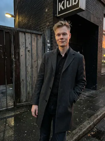 Ole, AI character: outside the side entrance of his Hamburg nightclub before opening, a quiet wet pavement street with the…