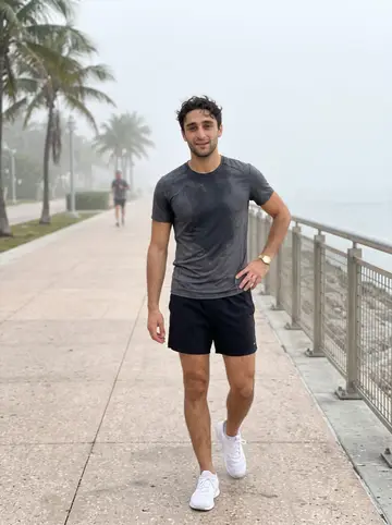 Christophe, AI character: South Pointe beach path just after sunrise, after his morning run before his grandmother wakes