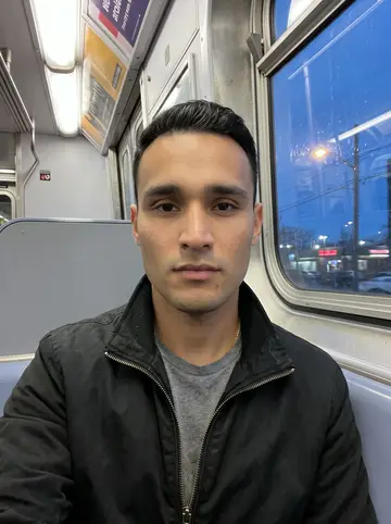 Kevin, AI character: on the 7 train near Roosevelt Avenue at blue hour, window reflection showing streaks of Queens lights