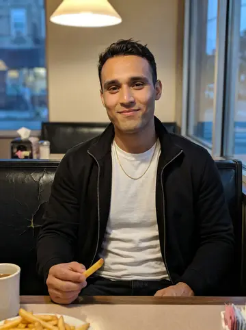 Kevin, AI character: a late-night diner booth in Jackson Heights after closing the laundromat, a plate of fries and a coffee on…