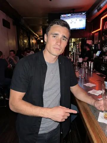 Noël, AI character: a narrow Montreal bar with a hockey game playing on a small TV over the counter