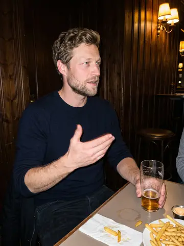 Eirik, AI character: a wood-panelled pub in Trondheim on a Friday night, a pint glass and a plate of fries on the table