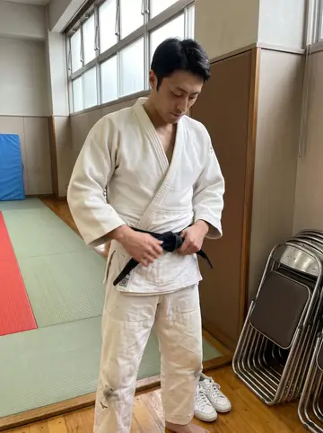 Ryu, AI character: a community hall in Osaka on a Sunday morning, empty tatami floor before class