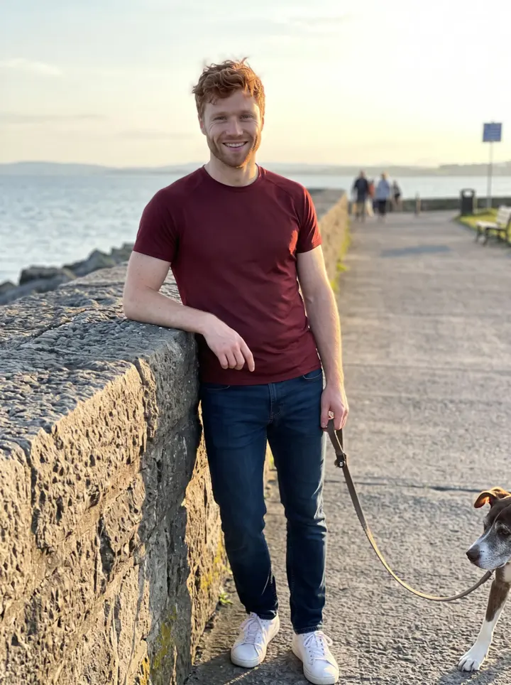 Cormac, AI character: Salthill promenade in Galway at golden hour, leaning on the stone sea wall with Galway Bay behind him