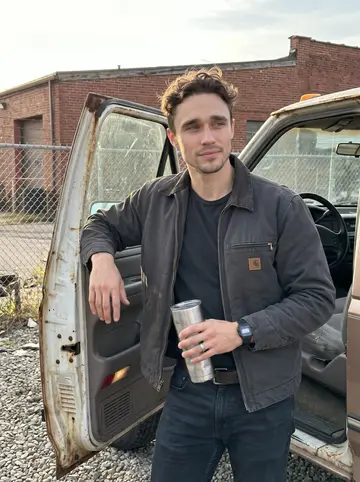Edwin, AI character: the tow yard on Cleveland's east side, beside his rusted 1998 Ford F-250 winch truck with the shop fence…