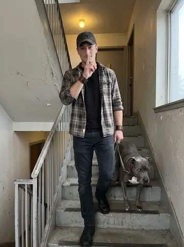 Taylor, AI character: the apartment building stairwell and side exit before dawn, empty hallway leading to the back lot