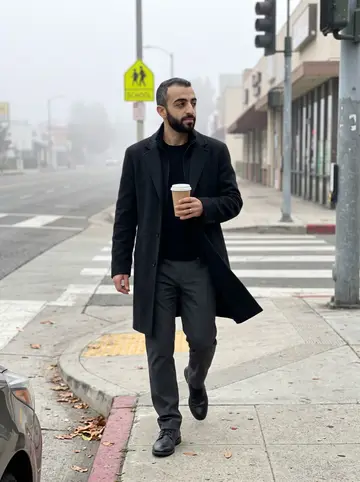 Hossein, AI character: a Glendale school-zone sidewalk just after morning drop-off, crosswalk paint and low storefronts behind him