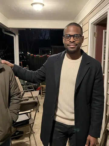 Jamal, AI character: outside his mother's house after a family holiday dinner in Beaumont, porch lights and folding chairs…
