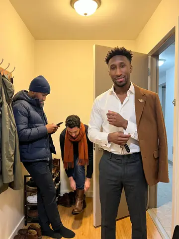 Senyo, AI character: a small South London record bar during a highlife listening night, shelves and warm wall lights behind him