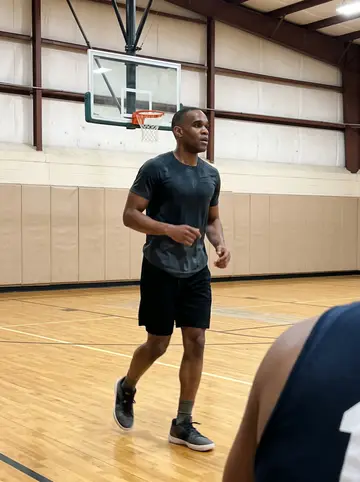 Shaquille, AI character: a neighborhood rec center basketball court in Atlanta after Sunday pickup, polished floor and wall padding…