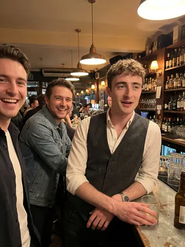 Luuk, AI character: a narrow Dutch-style brown café in downtown Holland, dark wood booth, small glass of jenever on the table,…