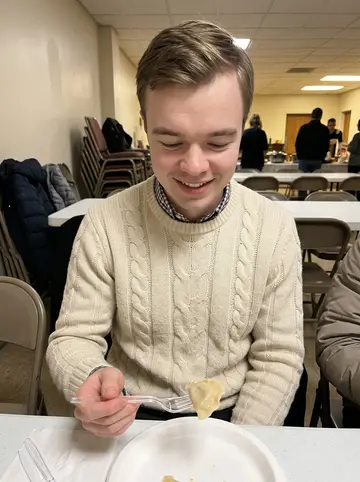 Loris, AI character: Sunday pierogi dinner in a church basement community room, folding tables and winter coats in the background