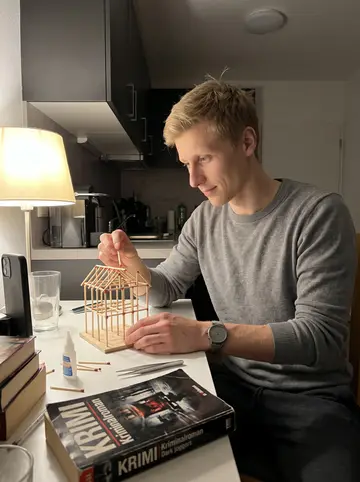 Roy, AI character: his Manhattan apartment kitchen table late at night, tiny matchstick model pieces laid out beside a German…