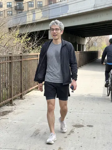 Albert, AI character: the 606 trail in Chicago on a bright spring morning, near a painted overpass after his run