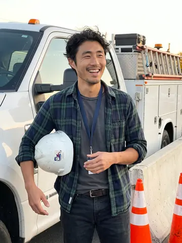 Kenneth, AI character: outside a low concrete bridge inspection site in San Jose at the end of a mild autumn workday, orange…