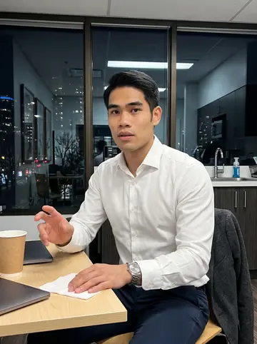 Jeremy, AI character: quiet downtown Vancouver office pantry after a late client meeting, paper coffee cups and a closed laptop…