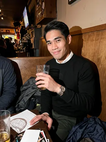 Jeremy, AI character: a crowded Vancouver pub trivia night with his team Sorry, Not Sorry, rain jackets piled on the booth…