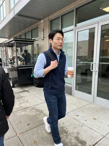 Jason, AI character: outside his logistics company office building in Jersey City during a quick weekday coffee run