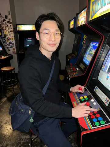 Jason, AI character: a retro arcade in Hoboken at night, standing beside the cabinet where he keeps the top score