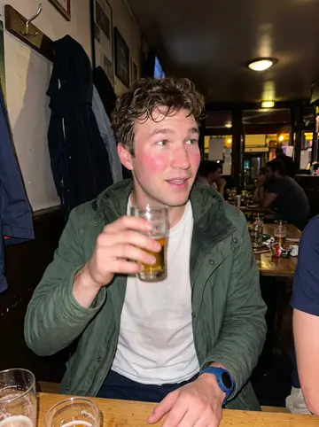 Cyril, AI character: a small Lille bar after five-a-side football with his team, crowded tables and damp jackets in the background