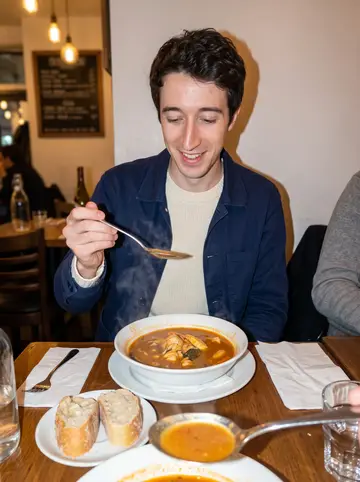 Titouan, AI character: a small crowded fish restaurant near the Vieux-Port after he argued at the market about bouillabaisse…