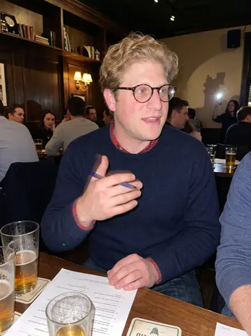 Ciarán, AI character: a crowded Irish pub quiz night in Chicago, standing beside a high table with answer sheets and pint glasses