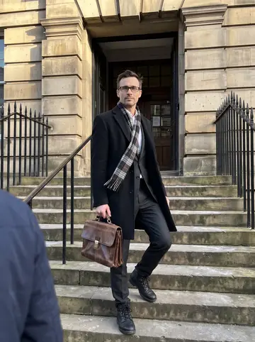 Seamus, AI character: outside the High Court in Edinburgh on a clear cold morning, stone steps and black railings visible