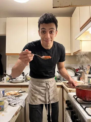 Lucio, AI character: his grandmother's apartment kitchen in Bensonhurst on a Sunday night, red sauce pot on the stove, small…
