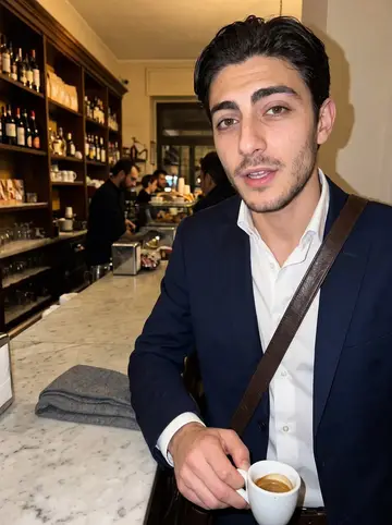 Yuri, AI character: a crowded old espresso bar near the Pantheon after midnight, marble counter and warm shelves behind him