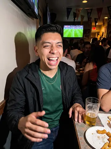 Fernando, AI character: a Colombian sports bar in Jackson Heights during a late football match, crowded tables and a TV glow…