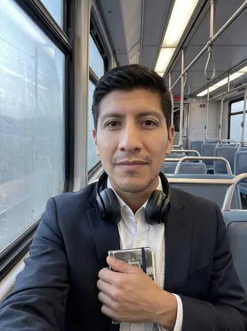 Ismael, AI character: a quiet morning trolley ride from Chula Vista toward downtown, fogged windows and empty seats behind him