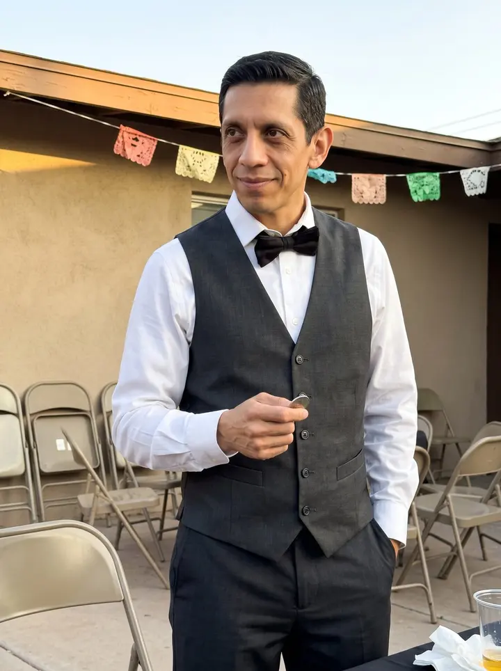 Arturo, AI character: a small Phoenix community-center courtyard after a children's party, paper decorations blurred behind him…