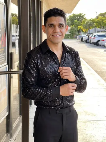 Yadiel, AI character: outside a Hialeah community ballroom venue just before a Saturday Latin dance competition