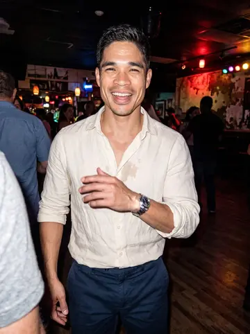 Yordan, AI character: a Little Havana salsa bar with colored lights and a small dance floor behind him