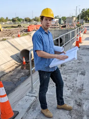 Aurelio, AI character: a Tampa stormwater pump station site, concrete channel and orange cones behind him