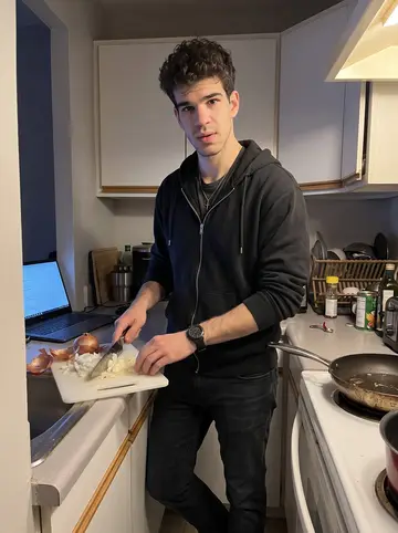 Artur, AI character: small apartment kitchen across the hall, laptop playing a cooking video on the counter, a dented pan on…