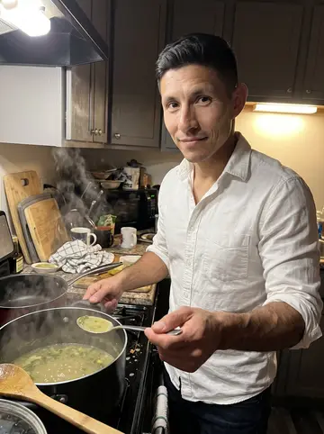 Tadeu, AI character: his Ironbound apartment kitchen late at night while caldo verde simmers on the stove