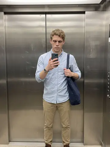 Joey, AI character: elevator in the downtown Columbus office building on a hot weekday, brushed metal doors and a floor…