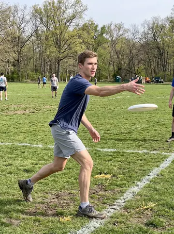 Sebastian, AI character: Fairmount Park on a Sunday morning pickup ultimate field, grass still bright from spring sun