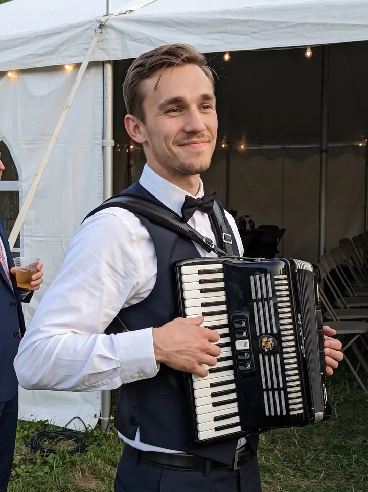 Jasper, AI character: outside a Pittsburgh wedding tent after a Saturday polka set, string lights starting to glow and folding…